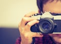 Young man is taking a picture with a vintage camera Royalty Free Stock Photo