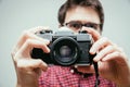 Young man is taking a picture with a vintage camera Royalty Free Stock Photo