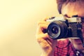 Young man is taking a picture with a vintage camera Royalty Free Stock Photo