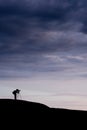 Young man taking pictures on the mountain peak Royalty Free Stock Photo