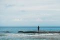 young man taking pictures of the sea standing on the shore Royalty Free Stock Photo