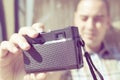 Young man taking a selfie with an old film camera, filtered Royalty Free Stock Photo
