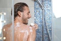 Young man taking shower with soap Royalty Free Stock Photo