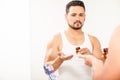 Young man taking some pills in the bathroom Royalty Free Stock Photo