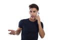Young man talking effusively by phone mobile in a photo studio