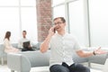 Young man talking on a mobile phone in the lobby of the business center Royalty Free Stock Photo