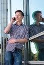 Young man talking on mobile phone outdoors Royalty Free Stock Photo