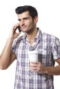 Young man talking on mobilephone drinking coffee Royalty Free Stock Photo