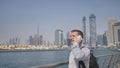 Young man talking on the phone on the background of the panorama of Dubai. Hand close-up.