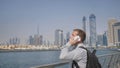 Young man talking on the phone on the background of the panorama of Dubai. Hand close-up.