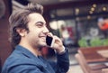 Young man talking phone in cafe Royalty Free Stock Photo