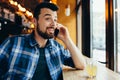 Young man talking on the phone in cafe Royalty Free Stock Photo