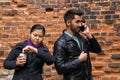 Young man talking on the phone, girl misses and gestures impatience