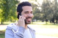 Young man talking on the phone. Outdoors. Royalty Free Stock Photo