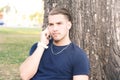 Young man talking on the phone. Outdoors. Royalty Free Stock Photo