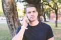 Young man talking on the phone. Outdoors. Royalty Free Stock Photo