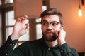 Young man talking by phone and waving look aside. Royalty Free Stock Photo