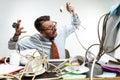 Young man tangled in wires on the workplace