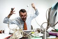 Young man tangled in wires on the workplace