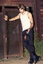 Young man in tank top holding hat