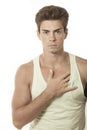 Young man singlet top with touching chest. Hairstyle fashionable