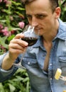 Young man tasting red wine, outside Royalty Free Stock Photo