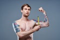 young man with tattoo and tape measure inflated muscles fitness bodybuilder model Royalty Free Stock Photo