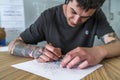Young man tattooed drawing a tattoo