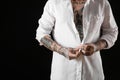 Young man with tattoos on body against black background, closeup Royalty Free Stock Photo