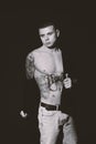 Young man with tattoos on dark background. Black and white photography Royalty Free Stock Photo