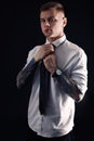 Young man with tattoos wearing shirt and tie on black background Royalty Free Stock Photo