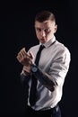 Young man with tattoos and wristwatch on black background Royalty Free Stock Photo