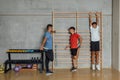 Young man teenagers stretching on the wooden gymnastics wall bars in gym Royalty Free Stock Photo