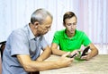 The young man tells his grandfather about the phone.