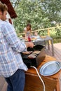 Young man on terrace grilling meat on barbecue Royalty Free Stock Photo