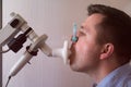 Young man testing breathing function by spirometry