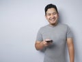 Young Man Texting Reading Chatting on His Phone, Smiling Happy Royalty Free Stock Photo