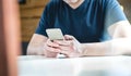 Young man texting with smartphone. Guy using mobile phone. Royalty Free Stock Photo