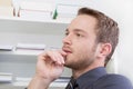 Young man thinking at office. Royalty Free Stock Photo