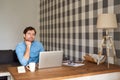 Young man thinking while working online at home Royalty Free Stock Photo