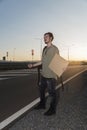 Young man thumbing on a highway Royalty Free Stock Photo