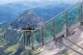 Young man with thumbs up at view platform Austrian Mountains