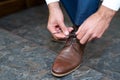 A young man ties the laces of his shoes - detail Royalty Free Stock Photo