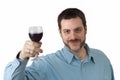 Young man toasting with glass of red wine Royalty Free Stock Photo