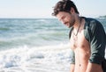 Young man topless outdoor portrait hiking near the sea Royalty Free Stock Photo