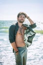 Young man topless outdoor portrait near the sea Royalty Free Stock Photo