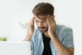 Young man touching temples trying to focus or feeling headache Royalty Free Stock Photo