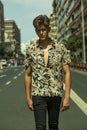 Young man with tough guy face walking in the middle of the street