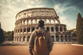 Young man tourist with backpack looking at Colosseum in Rome, Italy, Male tourist standing in front of a sandy beach and watching Royalty Free Stock Photo