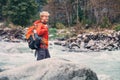 Young man tourist in mountain forest on the river bank Royalty Free Stock Photo